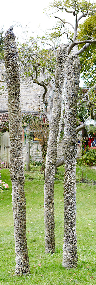 three totems with shell mosaic