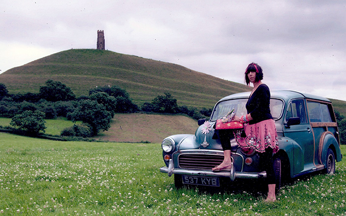 Candace Bahouth with her Morris Traveller at Glastonbury Tor